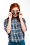 Portrait of beautiful ginger girl in sunglasses over white background.