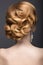 Portrait of a beautiful ginger woman in the image of the bride. Hairstyle back view