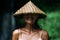 Portrait of a beautiful girl in an Asian conical hat. Portrait of a smiling girl. Beautiful smile. Close-up smile. Funny girl.