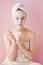 Portrait of beautiful girl in bathrobe with a cup of tea, relaxation concept blonde woman wearing bathrobe and towel on head after