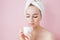 Portrait of beautiful girl in bathrobe with a cup of tea, relaxation concept blonde woman wearing bathrobe and towel on head after