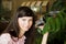 Portrait of beautiful girl with butterfly in a greenhouse