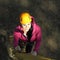 Portrait of beautiful girl in climbing gear. Beautiful girl climber climbs up the stairs.