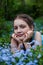 Portrait of   beautiful girl   in forget me not flowers