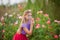 Portrait of a beautiful girl in the garden of a tea rose in spring.