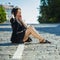 Portrait of a beautiful girl in a hat. an image of a hipster girl posing on an old cobblestone street