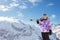 Portrait of beautiful girl hold ski over mountain