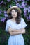 Portrait of a beautiful girl in a lilac garden. A woman walks in a flowered park. Summer holiday in the garden. Outdoor fashion ph