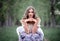 Portrait of a beautiful girl with long hair sitting in a chair on the background of a summer forest. Fashion outdoor shot of a