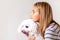 Portrait of beautiful girl and maltese dog in profile.