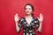 Portrait of a beautiful girl on a red background, which shows different emotions. Human face expression, emotions