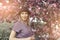 Portrait of a beautiful girl among spring foliage and flowers