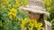 Portrait beautiful girl in straw hat with yellow sunflowers on village field. Happy young girl smiling with sunflowers