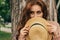 Portrait of a beautiful girl who stands near a tree. summer, walk in nature, red-haired girl in a vintage dress and a beige sweate