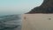 Portrait of beautiful girl and young man walking on the beach, drone aerial view. harm of nature, sea, waves, sand and