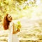 Portrait of beautiful happy ginger girl with yellow leaves in th