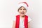 Portrait of beautiful happy laughing boy in red Santa Claus hat isolated on white background. Five-year little european child.