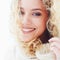 Portrait of beautiful happy woman with curly hair and adorable smile