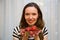 Portrait of a beautiful happy woman in the window with strawberries. Beauty youth happiness