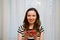 Portrait of a beautiful happy woman in the window with strawberries. Beauty youth happiness