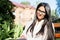 Portrait of a beautiful indian girl. Business woman in glasses sits on a bench, writes in a notebook