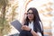 Portrait of a beautiful indian girl. Business woman, student, with a serious face, glasses, uses a tablet. Sitting on the steps of