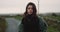 Portrait of a beautiful lady brunette in the middle of road countryside , looking straight to the camera and moving