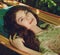 portrait of beautiful lady in the garden hammock, spring or summer seaason, outdoor portrait