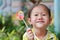 Portrait of a beautiful little asian girl holding a big round swirl lollipop. Beautiful little girl with lollipop