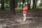 Portrait of a beautiful little girl 4 years old in a red sweater in autumn