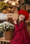 Portrait of a beautiful little girl with  flowers in autumn gazebo