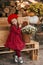 Portrait of a beautiful little girl with  flowers in autumn gazebo