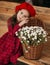 Portrait of a beautiful little girl with  flowers in autumn gazebo