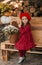 Portrait of a beautiful little girl with  flowers in autumn gazebo