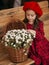 Portrait of a beautiful little girl with  flowers in autumn gazebo