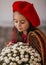 Portrait of a beautiful little girl with  flowers in autumn gazebo