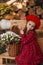 Portrait of a beautiful little girl with  flowers in autumn gazebo