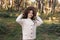 Portrait of beautiful little girl in hat looking at camera and smiling. Happy cute child having fun in park outdoors