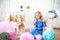 A portrait of a beautiful little girl in a studio decorated many color balloons