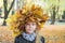 Portrait of a beautiful little girl in a wreath of maple leaves