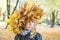 Portrait of a beautiful little girl in a wreath of maple leaves