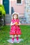 Portrait of beautiful little gorgeus lovely toddler girl in pink summer look clothes, fashion dress, knee socks and hat