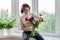 Portrait of beautiful mature woman with bouquet at home