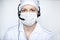 Portrait of a beautiful medical woman wearing protective mask with handset