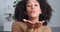 Portrait of beautiful mixed race curly girl friend cheerful afro american woman sends blowing air kiss. Close up of