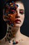 Portrait of a beautiful model with creative make-up made of various pasta pieces