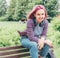 Portrait of Beautiful modern young female teenager with extraordinary hairstyle color in a checkered shirt with wireless