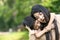 Portrait beautiful mother and child happily hugged in park. Asian family mom and child are hugging and looking at the camera, cute