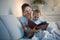 Portrait of beautiful mother reading book to her baby before going to sleep