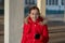 Portrait of a beautiful nine year old little girl. School child in winter clothes on the street. Girl 9 years old